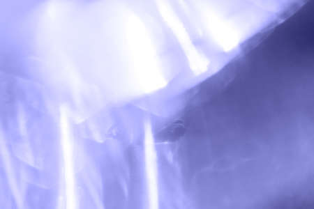 Purple abstract blurred background with sun rays.