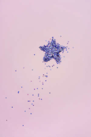 Star shape of purple sparkles on pink.