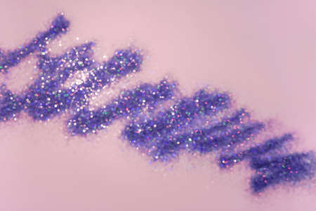Pink background with purple blurred sparkles bokeh.の写真素材