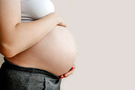 Pregnant woman holding her belly, copy space.の写真素材