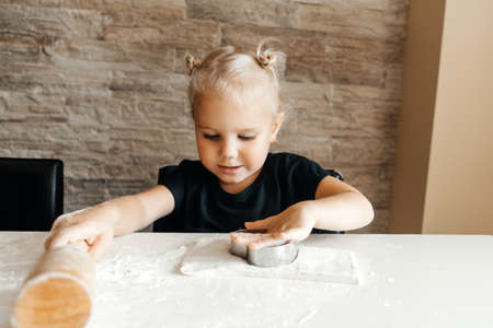 Girl making cookies in the kitchen at home.の写真素材