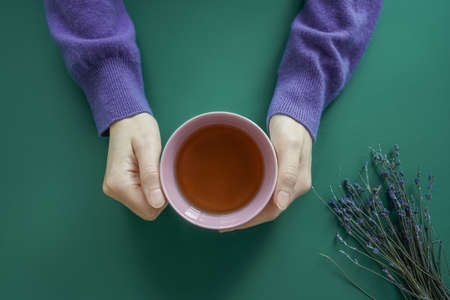 Dry Lavender flower bouquet and hands with cup.の写真素材