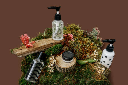 Cosmetics bottles with cream, sustainable design with moss.の写真素材