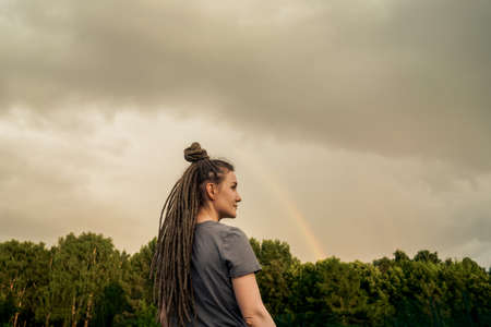 Profile view on smiling woman in park.の写真素材