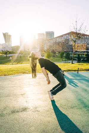 Woman with dreadlocks have fun in parkの写真素材