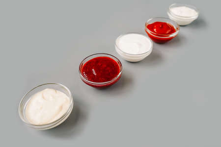 Various sauces in row on gray background, copy space. Top view.の写真素材