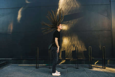 Young happy woman with dreadlocks in park