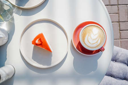 Cup of latte coffee with cheesecake top view.の写真素材