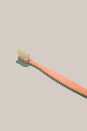 Natural bamboo toothbrush on mint background isolated. Overhead, copy spaceの写真素材