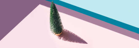 Christmas tree toy on pink and blue background. Christmas holiday celebration concept. Web banner.の写真素材