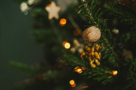 Beautiful decorated Christmas tree with nut. Boho design. Close up, copy space.の写真素材