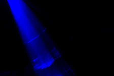 Blurred blue light bokeh in black background. copyspace.の写真素材