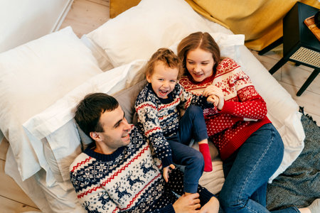 Happy family have fun on bed. Home.の写真素材