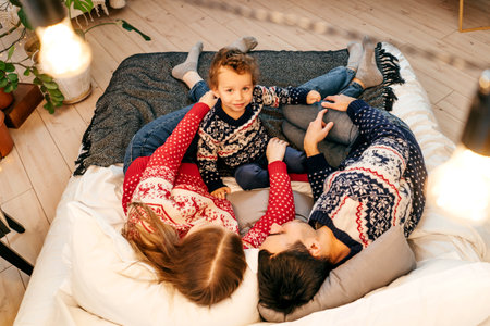 Happy family have fun on bed. Home.の写真素材