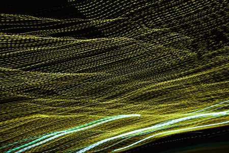 Abstract background with colorful stripes of neon light on a black background. Festive background.の写真素材