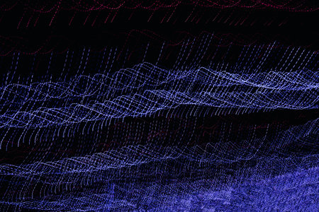 Abstract background with colorful stripes of neon light on a black background. Festive background.の写真素材