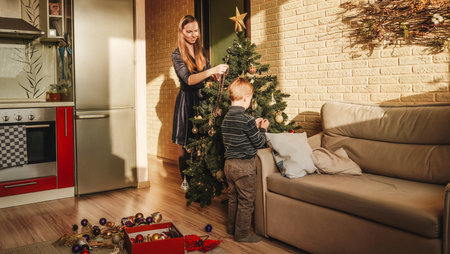 Happy family decorating a Christmas tree.の写真素材