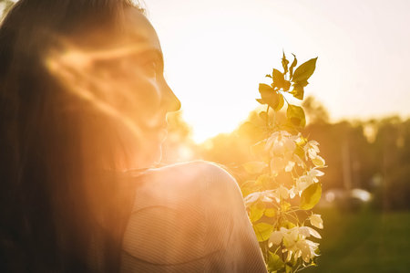 Branch of blossoming apple tree in womans hands.の写真素材