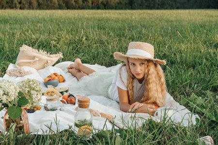 Woman read book on picnic in field.の写真素材
