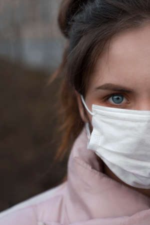 Portrait of a young girl wearing a maskの写真素材