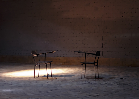 two chairs stand in a brick cellarの写真素材