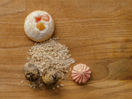 oatmeal and eggs and cookie and meringue on wooden table top viewの写真素材