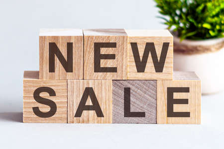 New sale motivation text on wooden blocks business concept white background. Front view concepts,...