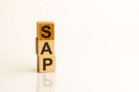 Wooden block with words HURT on wooden cubes, with the medical mask, health concept, yellow backgroundの写真素材