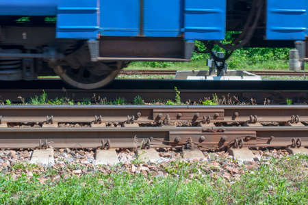 the blue train is moving on rusty rails.の写真素材