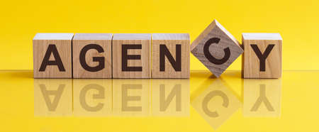 BONUS - word from wooden blocks with letters, concept, yellow background.の写真素材