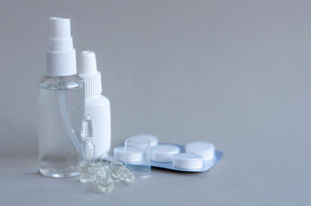 Glass medical ampoule vial for injection. Medicine is dry white drug penicillin powder or liquid with of aqueous solution in ampulla. Close up. Bottles ampule with aluminum cap on backgrounds gray.の写真素材