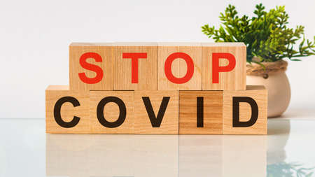 Stop covid word written on wood block. text on wooden table for your desing, Health and medicine concept. Healthcare conceptの写真素材