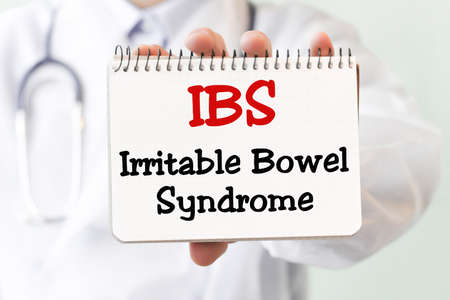 Doctor writing word IBS Irritable Bowel Syndrome with red marker, Medical conceptの写真素材