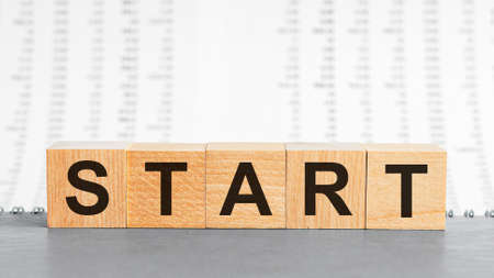Start word written on wood block. Start text on wooden table for your desing, concept.の写真素材