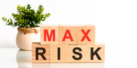 MAX RISK word written on wood block. Faqs text on table, concept. Red letter MAX.の写真素材