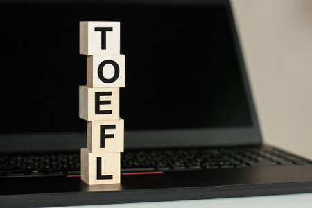 The word TOEFL in wooden cubes on the keyboardの写真素材