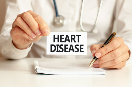 Heart Disease. Doctor holds a business card in his hand. Text is on the sign.の写真素材