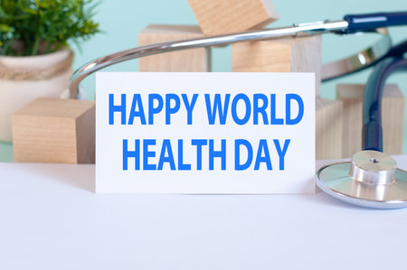 Card with words MEDICAL CHECKUP, stethoscope, wooden blocks and flower on table. Medical and healthcare concept. Soft blue backgroundの写真素材