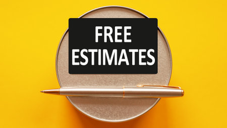 free estimates - words writing a white letters on a sheet paper. Black card with text on a yellow background with round metal stand and metal writing pen. Business, finance and education conceptの写真素材