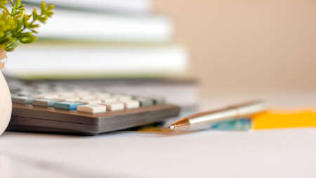 Close-up of silver pen and calculator on paper, business concept, selective focusの写真素材