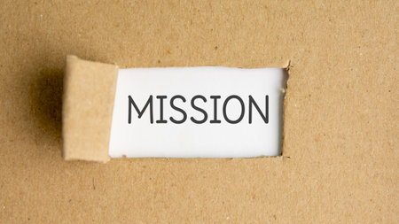 the text mission behind torn brown paper, concept.の写真素材