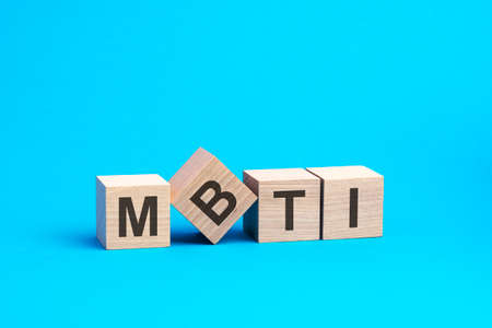 mbti text on wooden blocks, financial business concept, blue background. mbti-short forの写真素材