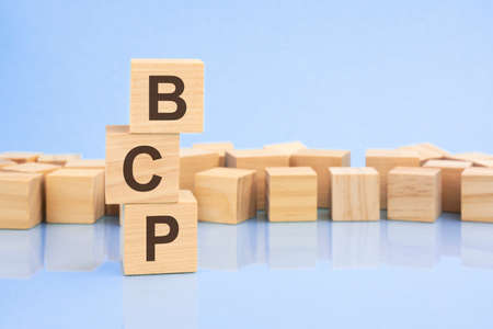 On a bright pale lilac background, light wooden blocks and cubes with the text BCP. cubes is reflected from the surface. BCP - short for Business Continuity Planの写真素材