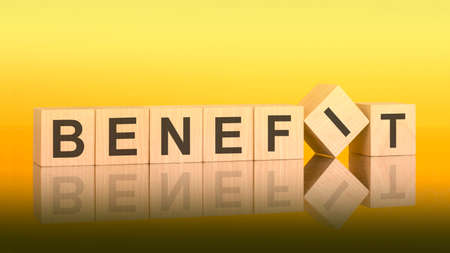 BENEFIT word written on wood block. yellow background. business concept. inscription on the cubes is reflected from the surface of the table. a color gradient is usedの写真素材