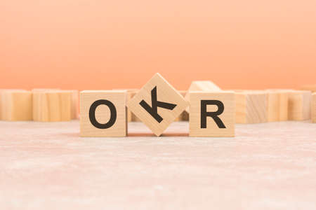OKR wooden blocks word on orange background. OKR - short for Objectives and Key Results, information conceptの写真素材