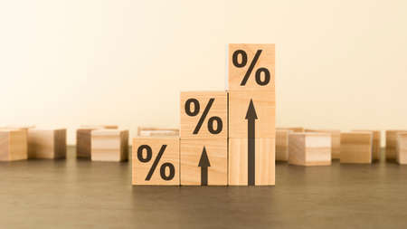 wooden cubes with percent signs. concept of financial and mortgage interest rate. gray background