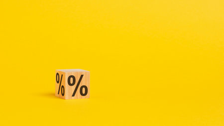 percent sign on wooden cubes against gray background with copy space. concept of sale and discount,...