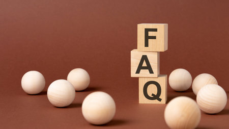 faq - frequency asked questions - letter pices on the wooden cubes, brown background.の写真素材