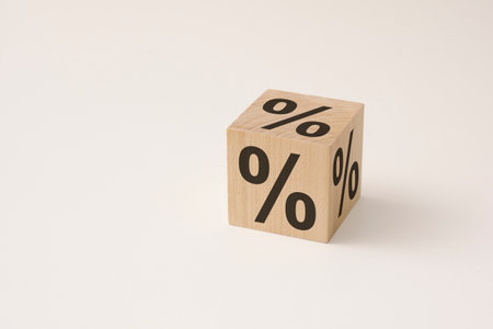 flipping a wooden cubic block to change the percent sign on a white background. credit history and sales conceptの写真素材