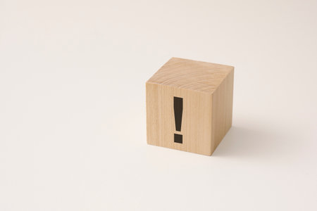 exclamation mark drawn on wooden block with copy spaceの写真素材